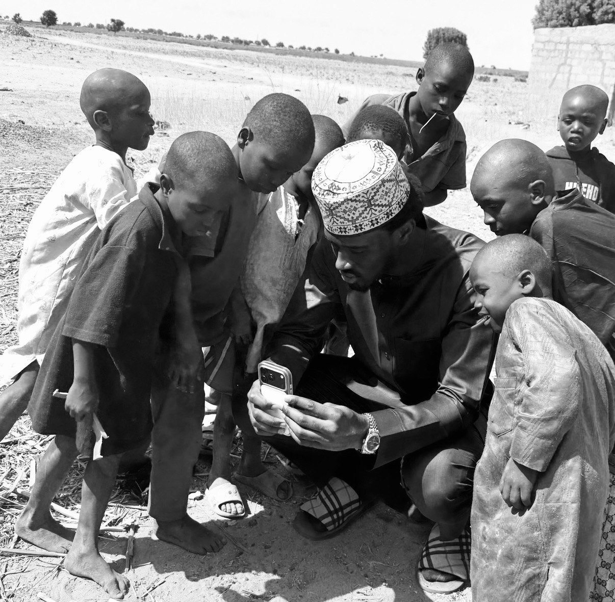 Ayman Garba Umar engaging with local children
